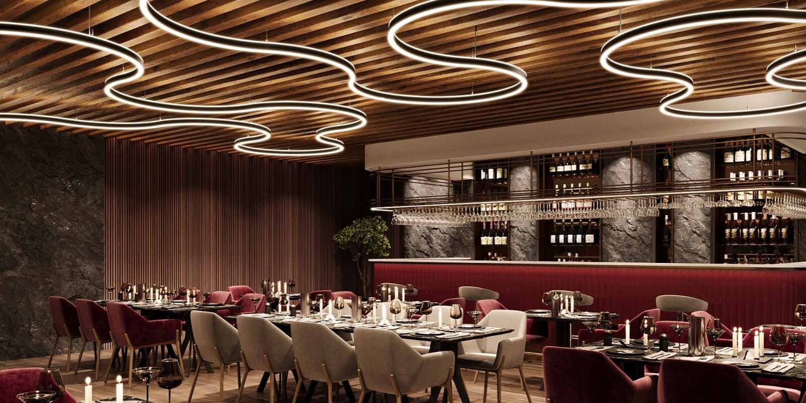 Untitled Design (14) Micro Squiggle Curvilinear Lighting System by Betacalco illuminating a dining room.